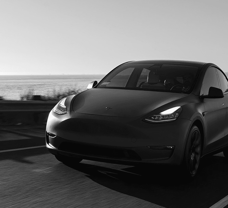 Front view of Tesla Model Y in motion, elegant black color
